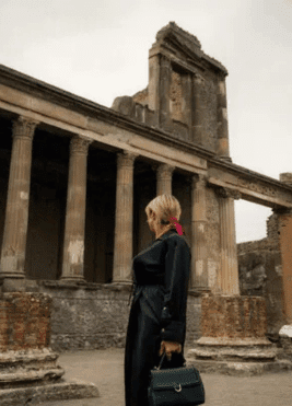 Tourist exploring the ancient ruins of Pompeii in Italy, a popular destination with inStazione Italy tours.