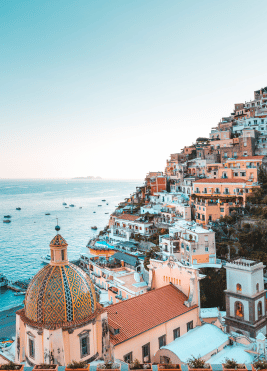 Scenic view of Italy's Amalfi Coast with cliffs, blue waters, and coastal architecture.