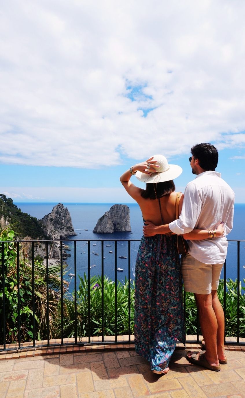 Couple enjoying panoramic Capri view during boat tour stop