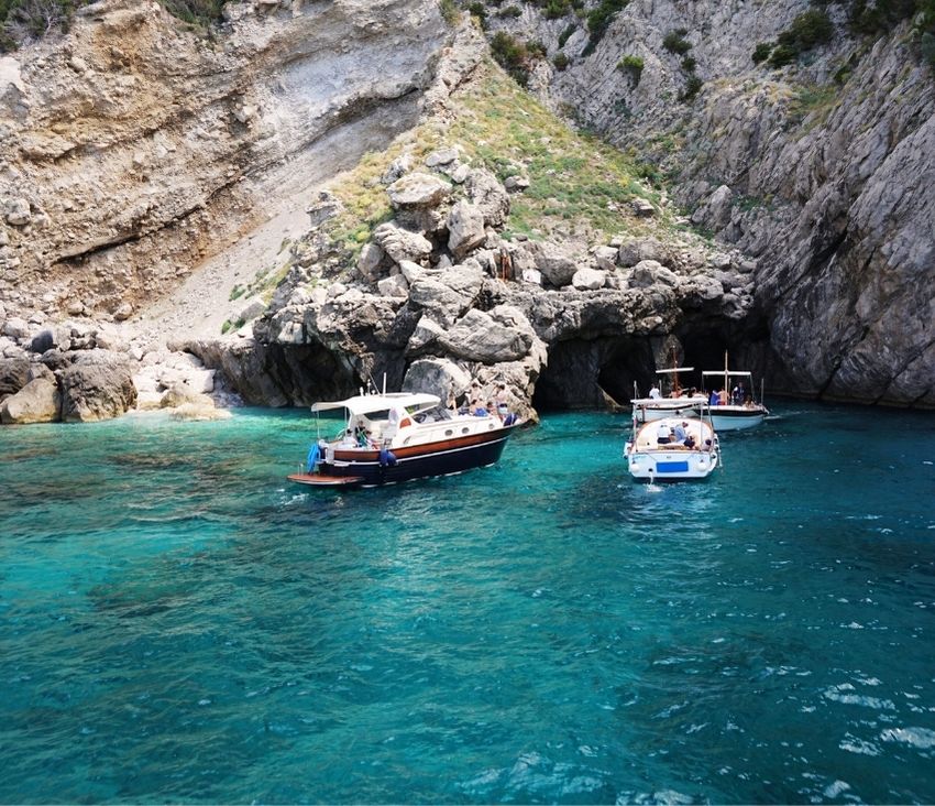 Boats anchored off Capri’s coast with crystal waters for swimming stop