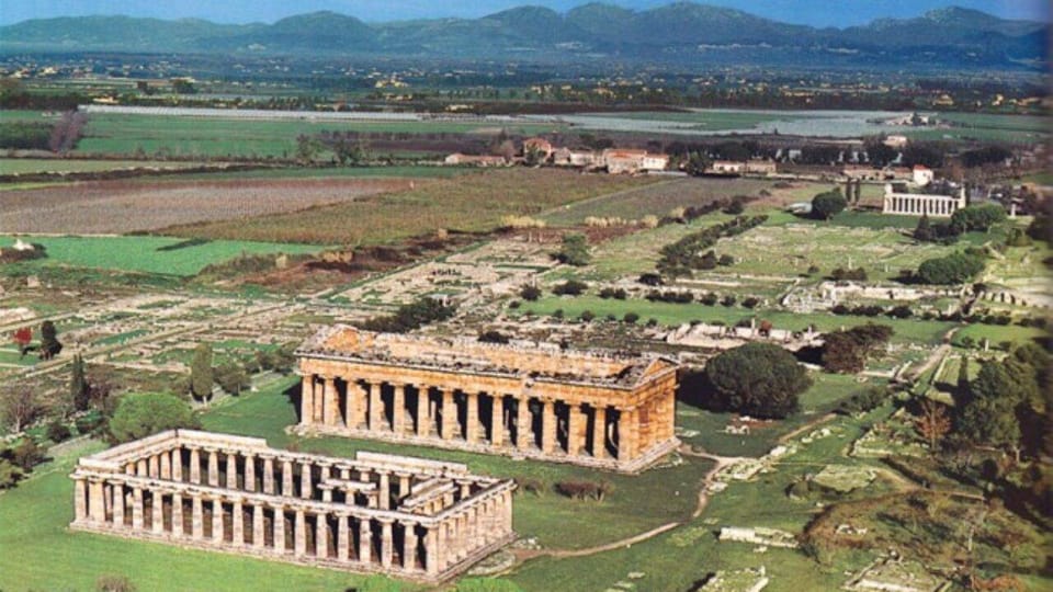 Aerial panorama of Paestum Archaeological Park temples and ancient city ruins