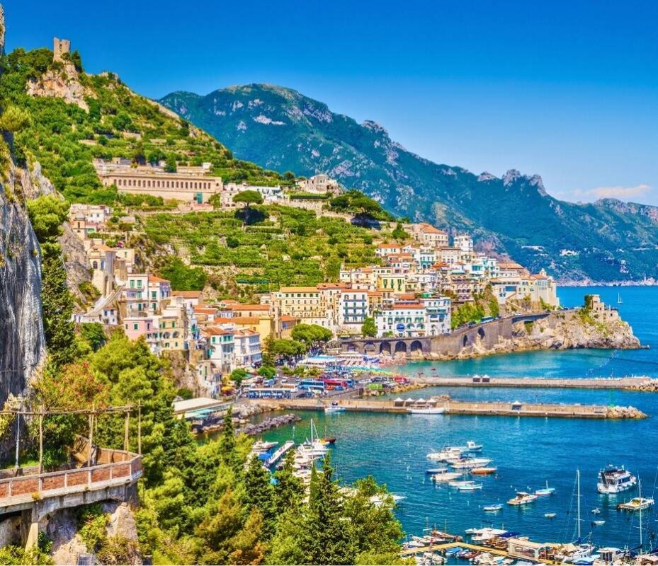 Colorful coastal town of Amalfi with boats in the harbor, seen during a Sorrento day trip from Naples
