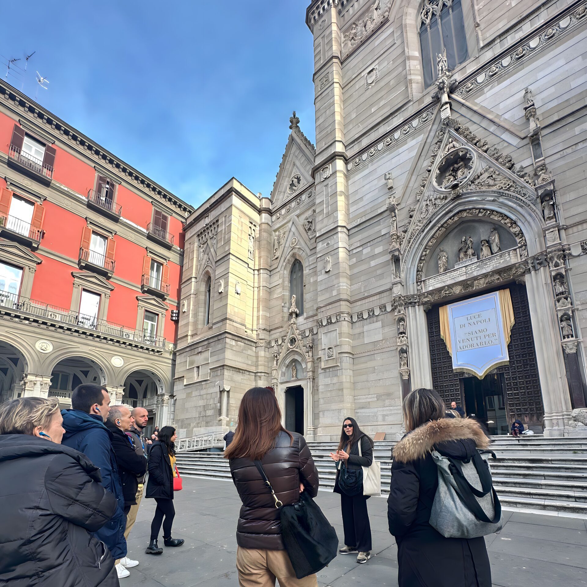 Tour group gathering at the entrance of Cappella Sansevero with their guide in Naples