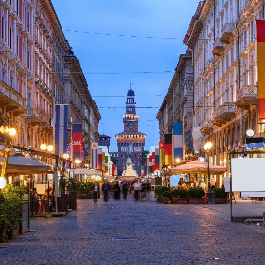 Evening view of Via Dante leading to Sforzesco Castle on Milan Walking Tour