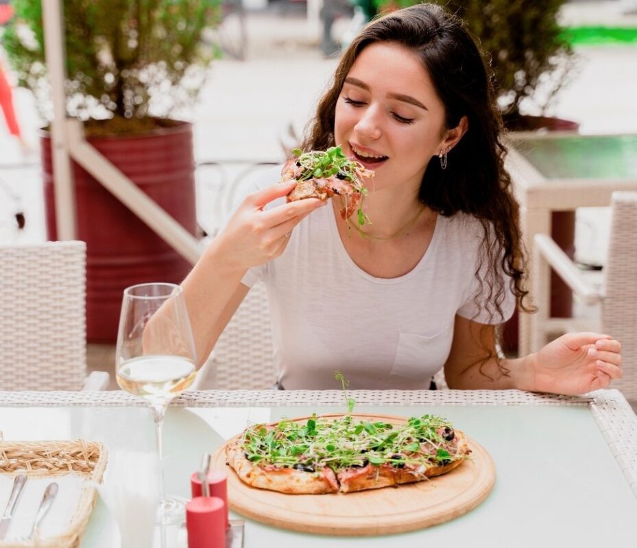 Woman enjoying pinsa during Rome Street Food Tour