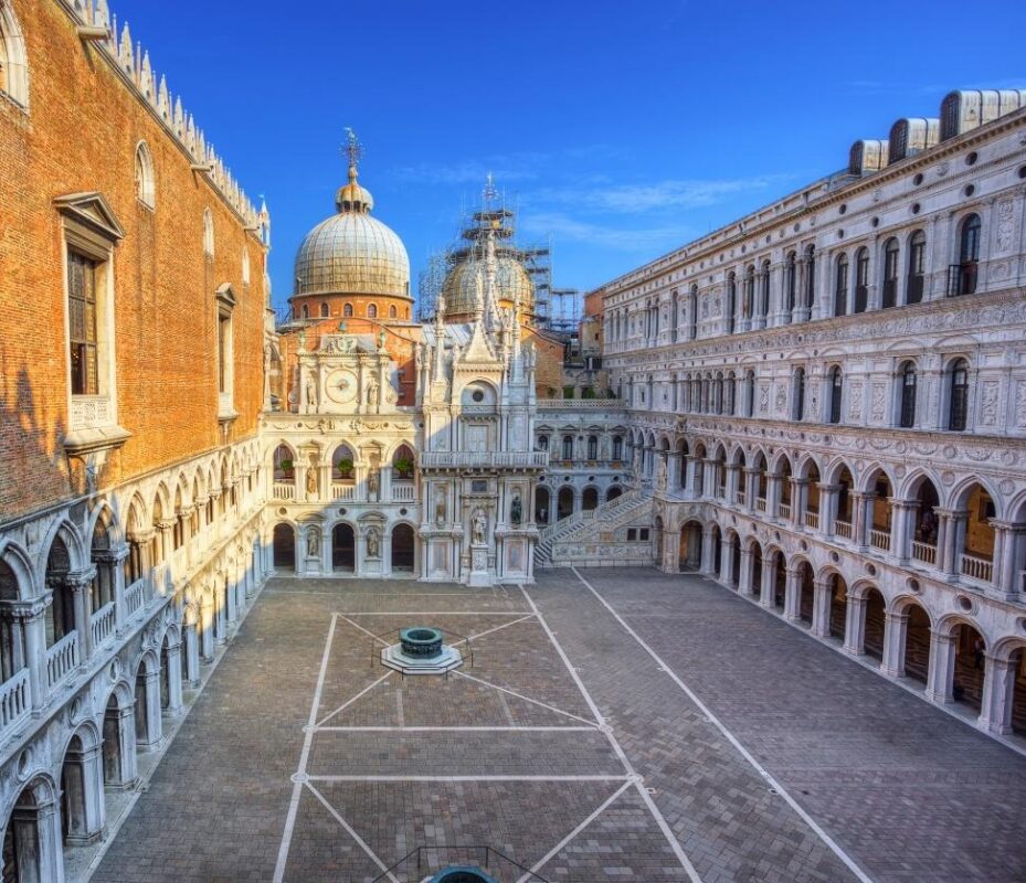 Interior courtyard of Doge’s Palace Venice with St. Mark’s Basilica domes in background