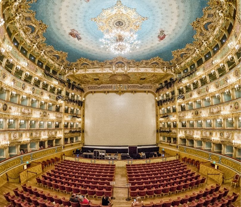 Ornate interior of La Fenice Theatre showcasing stage and audience seating