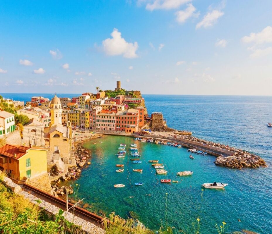 Coastal village in Cinque Terre perched on a rocky cliff with boats below, part of a Cinque Terre Day Trip from Florence