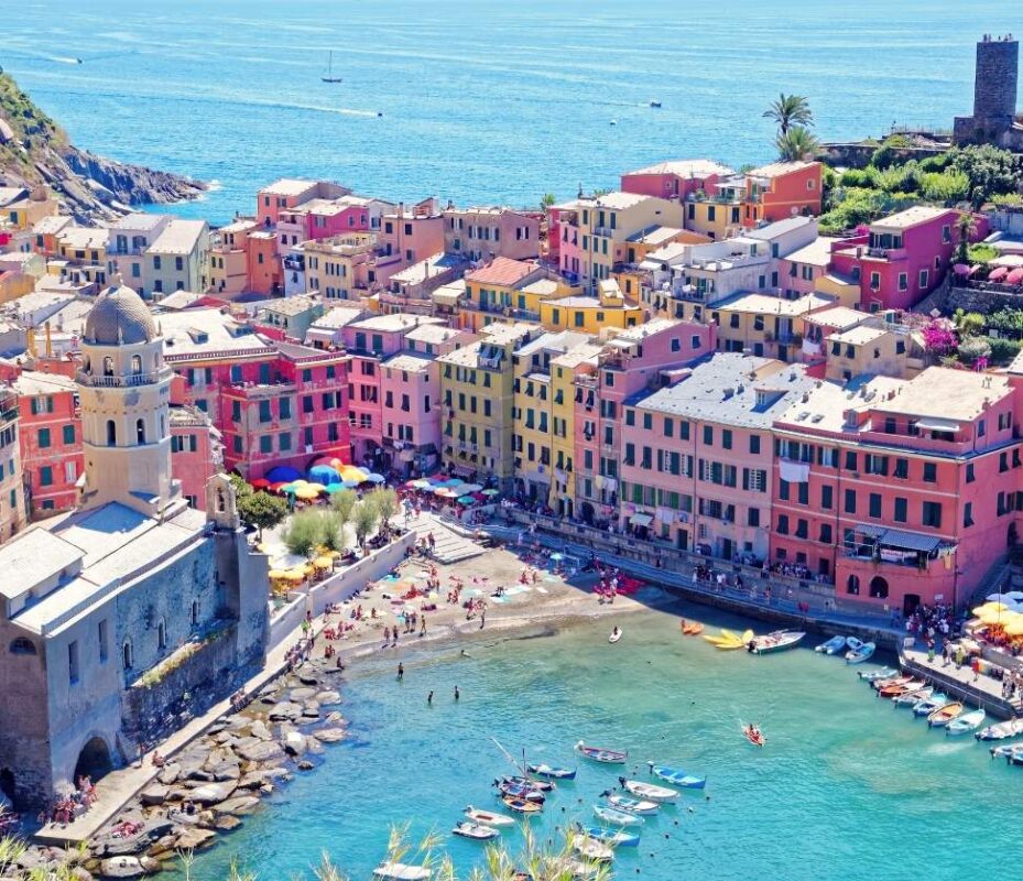 Aerial view of colorful coastal village in Cinque Terre with beach and boats, seen during a Cinque Terre Day Trip from Florence