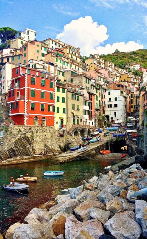 Colorful Riomaggiore village clinging to cliffs, seen during a Cinque Terre from Florence excursion
